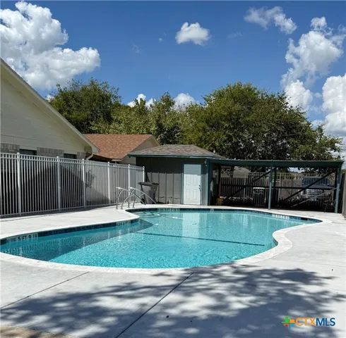 a view of a house with backyard and patio