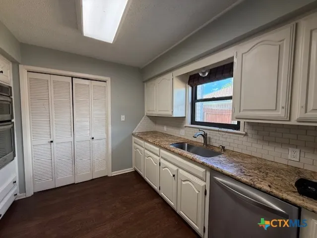 a kitchen with a sink and cabinets