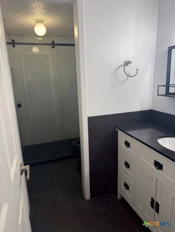 a bathroom with a shower and a mirror
