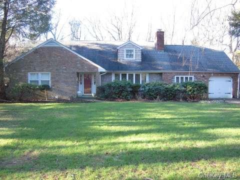 39 White Oak Tree Road Laurel Hollow, NY 11791 - Photo 1 of 1 a front view of a house with a yard