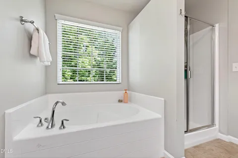 a bathroom with a tub and a window
