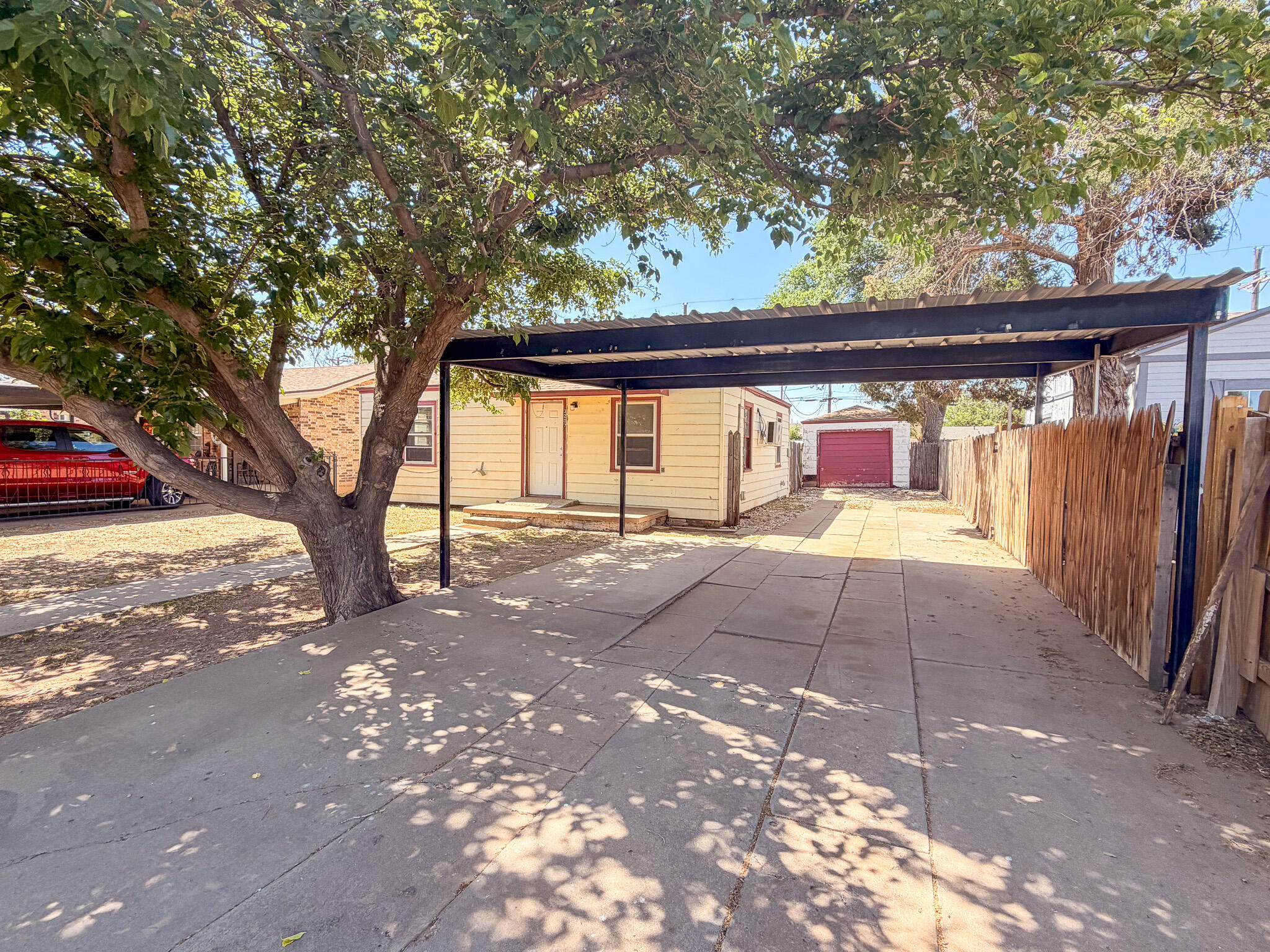 3207 Amherst Street Lubbock, TX 79415 - Photo 11 of 16 a view of backyard with large trees and a barn