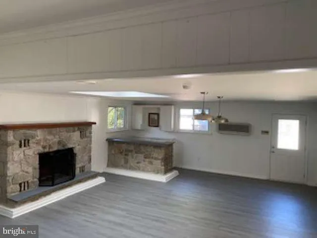a view of a livingroom with a fireplace and window