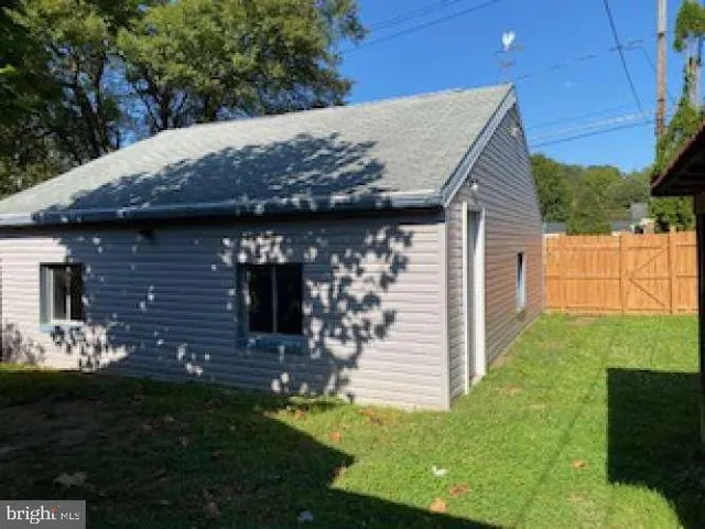 a view of house with backyard and garden