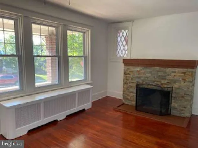 a living room with a fireplace and windows