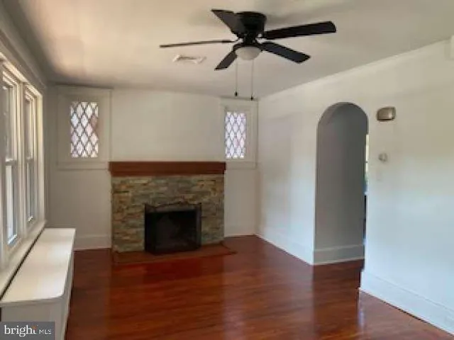 a view of a livingroom with a fireplace and wooden floor