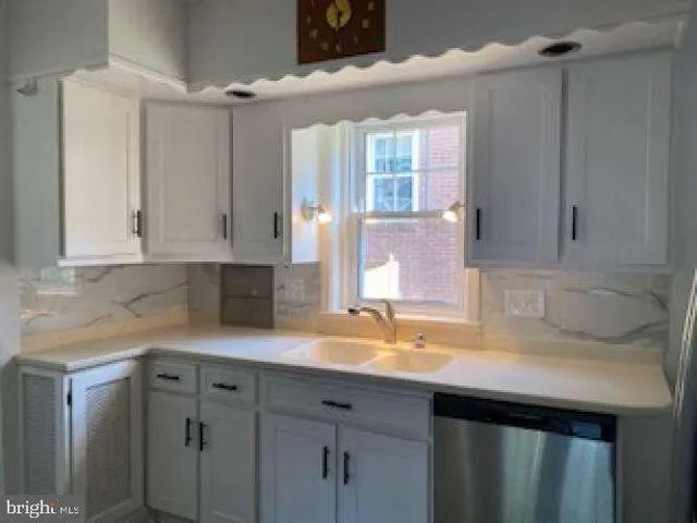a kitchen with a sink and cabinets