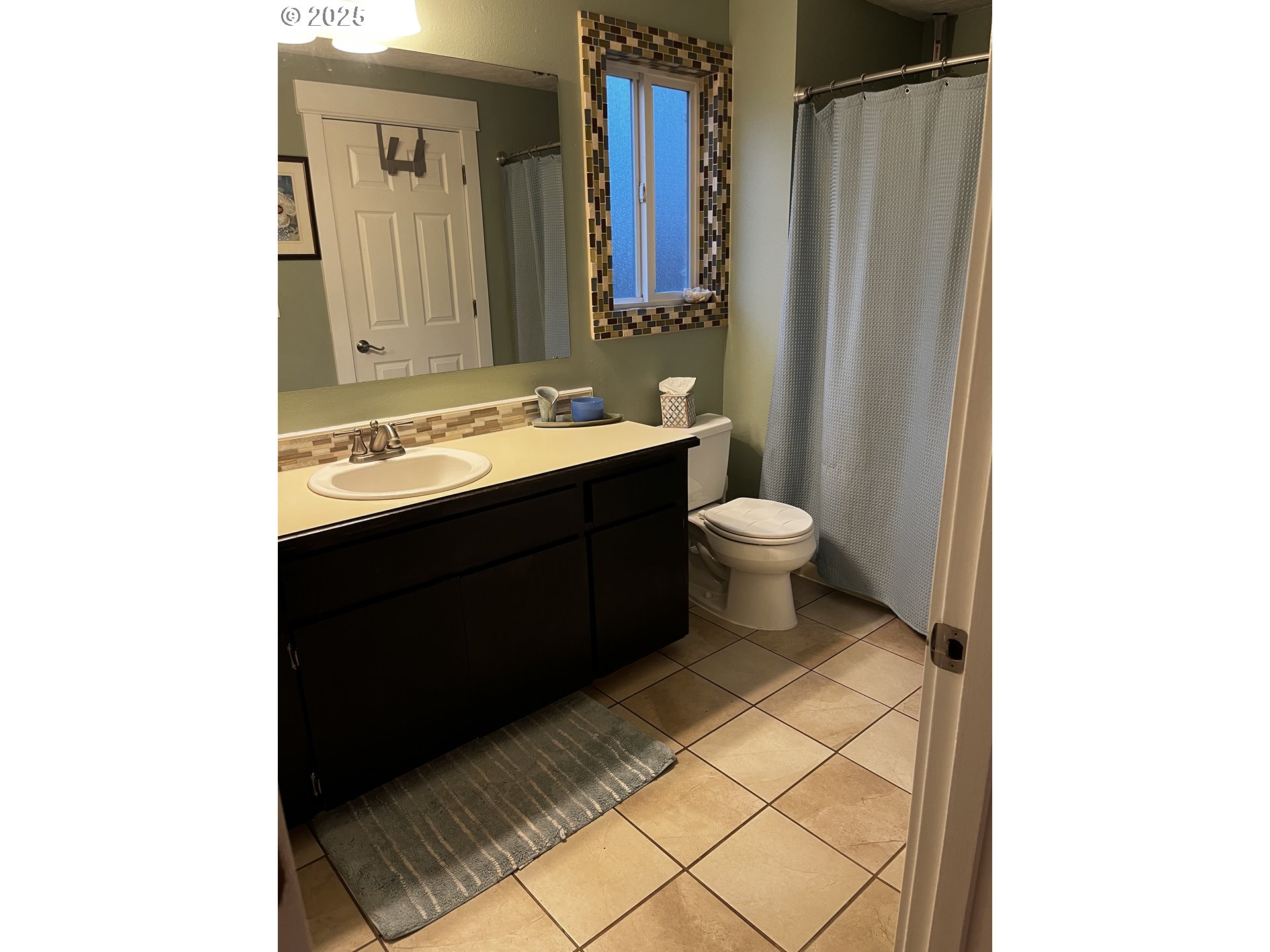 7473 B Street Springfield, OR 97478 - Photo 5 of 28 a bathroom with a sink and a mirror