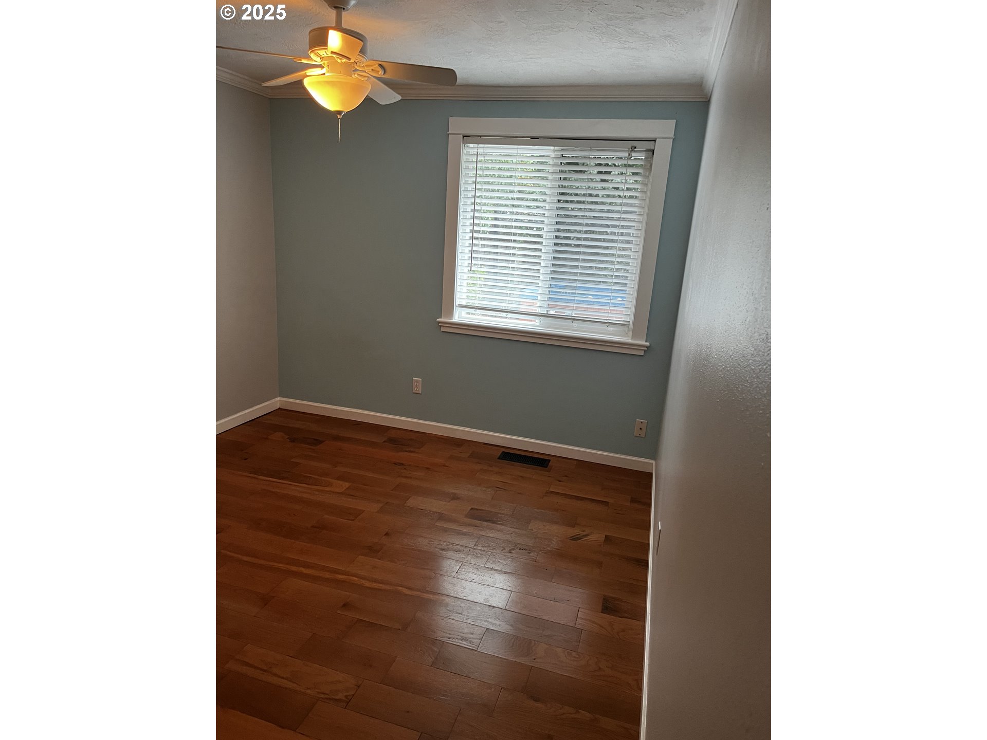 7473 B Street Springfield, OR 97478 - Photo 8 of 28 a view of an empty room with wooden floor and a window