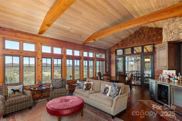 a living room with furniture and floor to ceiling windows
