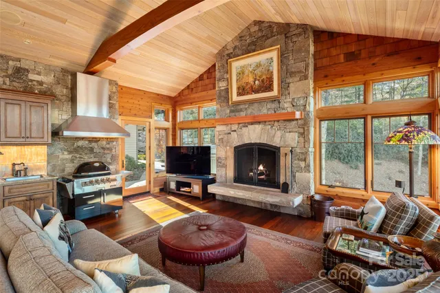 a living room with furniture a fireplace and a flat screen tv