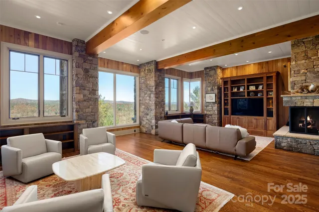 a living room with furniture and large windows