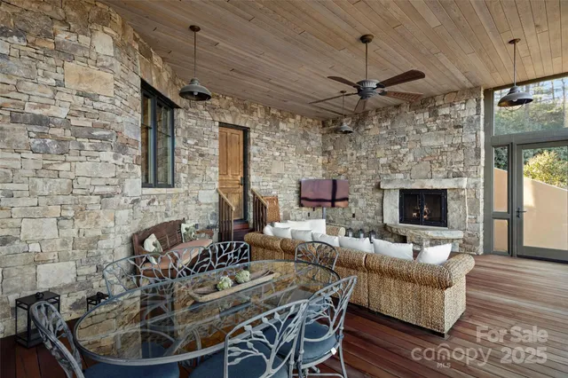 a living room with furniture a fireplace and a table