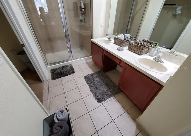 a kitchen with granite countertop a sink a stove and cabinets