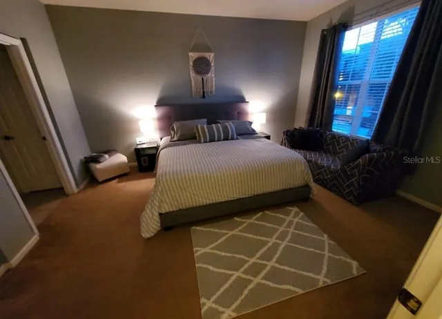 a bedroom with a bed and a window