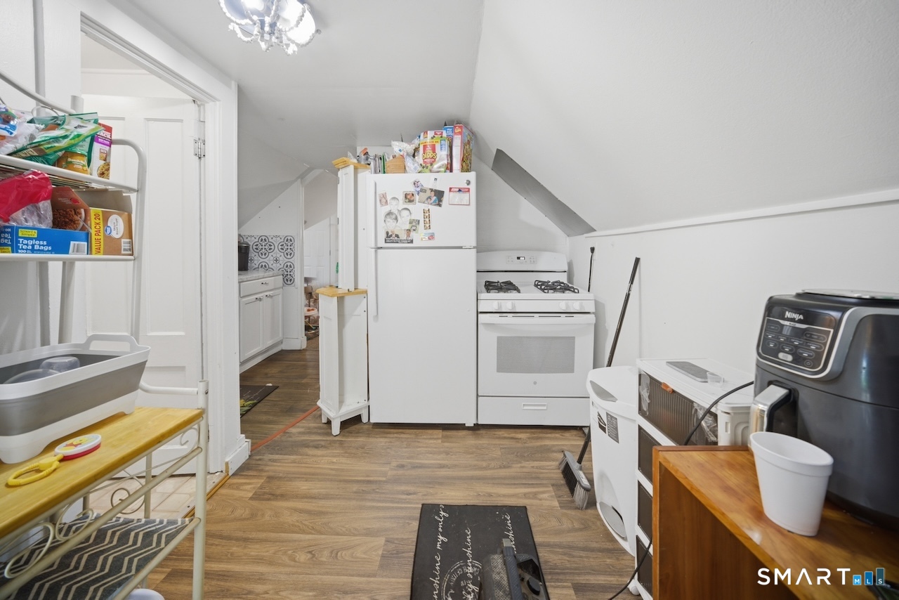 12 Webster Street Vernon, CT 06066 - Photo 20 of 33 a kitchen with a refrigerator and a stove