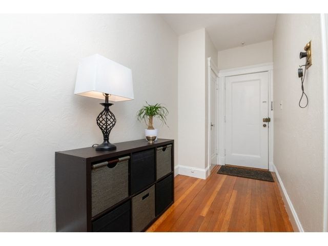 a view of hallway with wooden floor