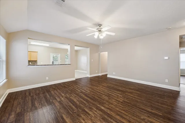 wooden floor in an empty room with a window