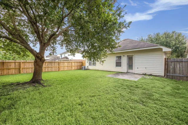 a view of a house with yard and a tree