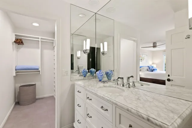 a bathroom with double vanity sink and a mirror