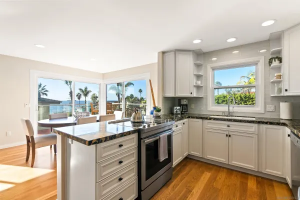 a kitchen with a sink stove and cabinets