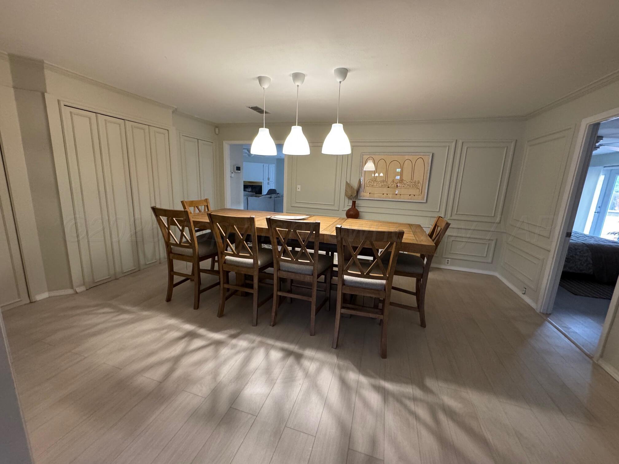 513 South Eton Street Perryton, TX 79070 - Photo 16 of 72 a view of a dining room with furniture and wooden floor