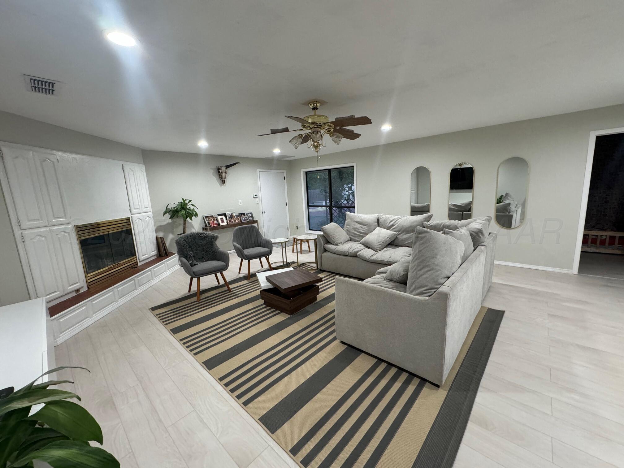513 South Eton Street Perryton, TX 79070 - Photo 21 of 72 a living room with furniture fireplace and flat screen tv