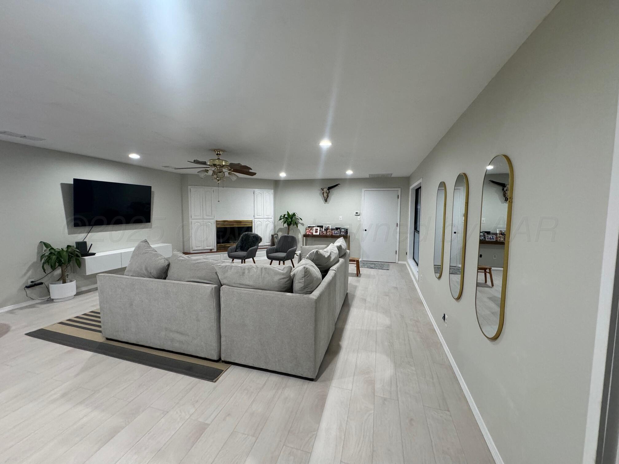 513 South Eton Street Perryton, TX 79070 - Photo 22 of 72 a living room with furniture and a flat screen tv