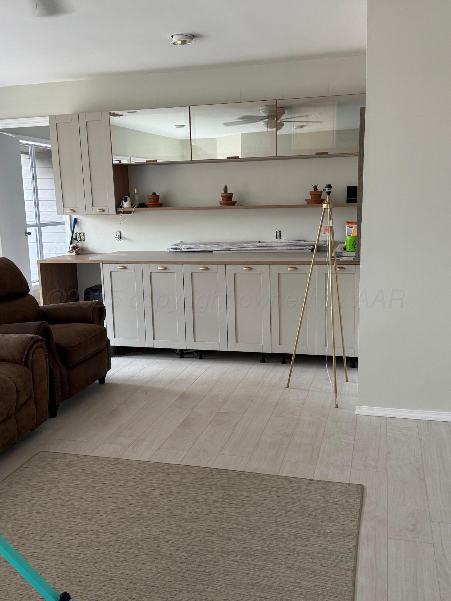 513 South Eton Street Perryton, TX 79070 - Photo 23 of 72 a kitchen with cabinets and chairs