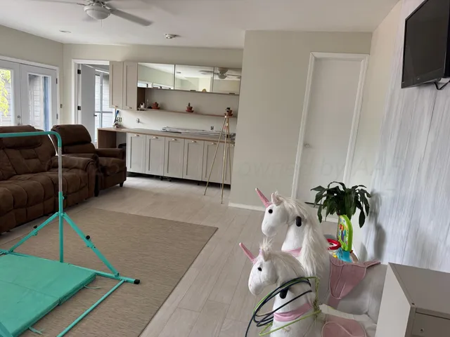 a large kitchen with a large counter top appliances and cabinets