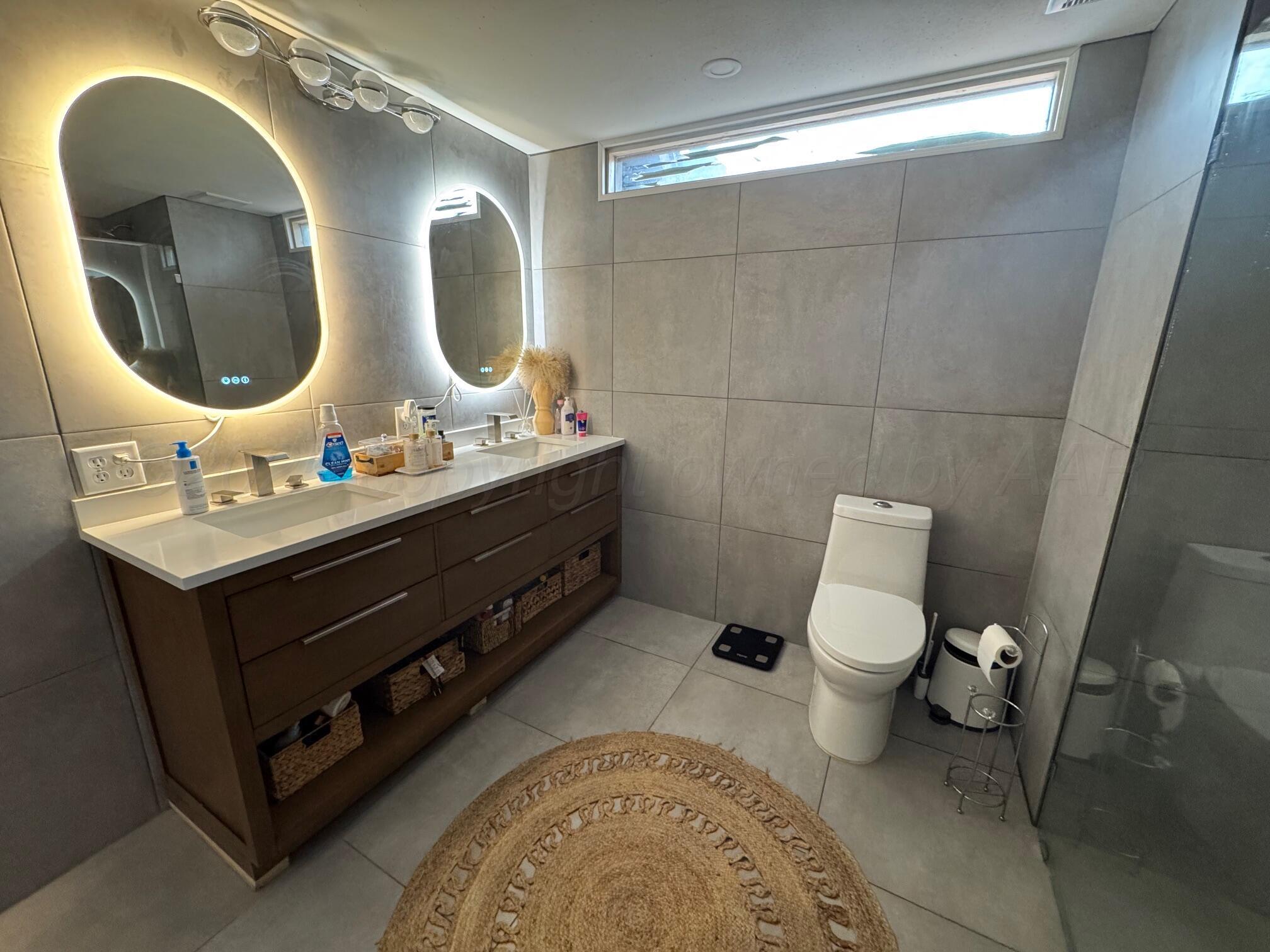 513 South Eton Street Perryton, TX 79070 - Photo 41 of 72 a bathroom with a toilet sink and mirror