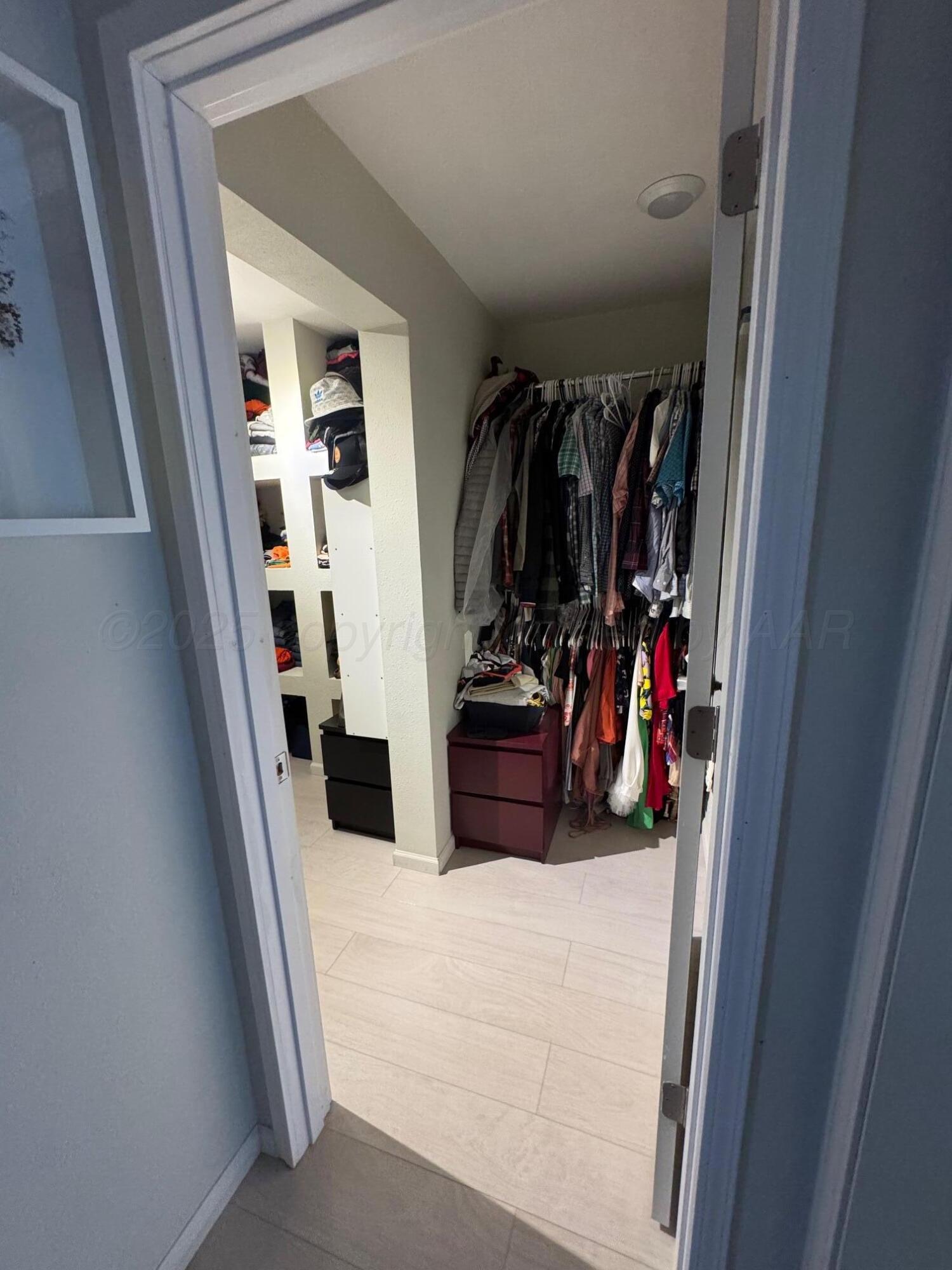 513 South Eton Street Perryton, TX 79070 - Photo 45 of 72 a view of walk in closet with clothes and shoes
