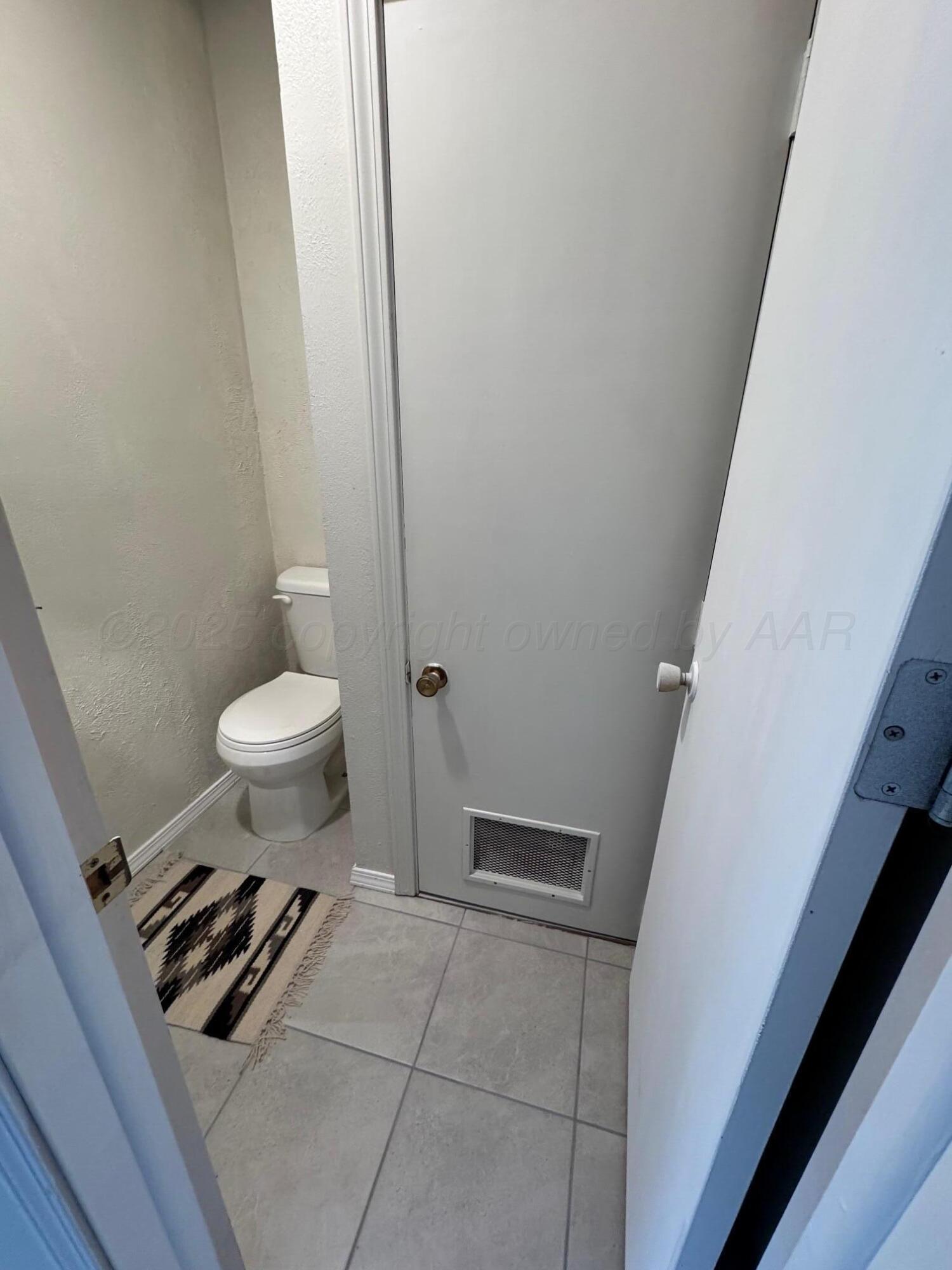 513 South Eton Street Perryton, TX 79070 - Photo 57 of 72 a bathroom with a toilet a sink a rug and a window