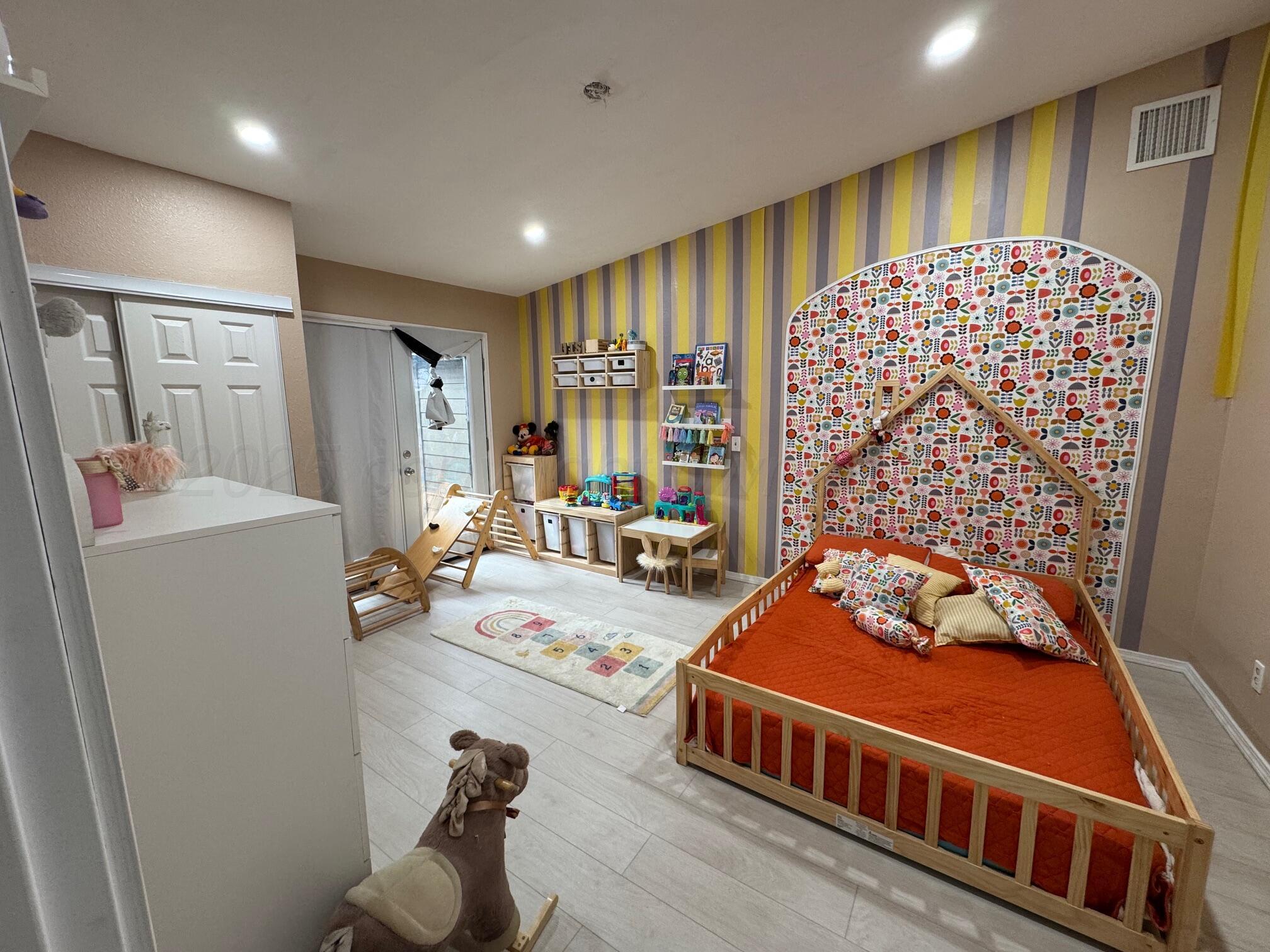 513 South Eton Street Perryton, TX 79070 - Photo 62 of 72 a bedroom with furniture and a large window