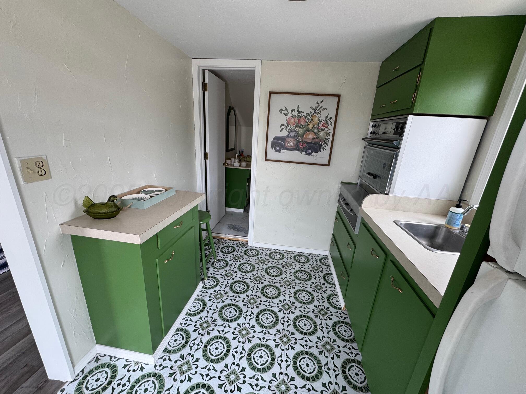 513 South Eton Street Perryton, TX 79070 - Photo 69 of 72 a view of a kitchen with fridge and workspace