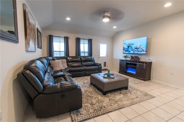 a living room with furniture and wooden floor