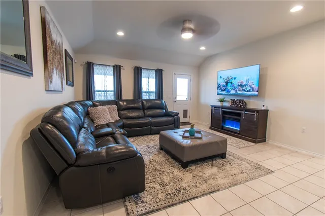 a living room with furniture and wooden floor