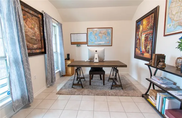 a view of a dining room with furniture and a window