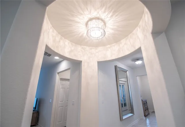 a kitchen with stainless steel appliances granite countertop a stove top oven a sink a dining table and chairs