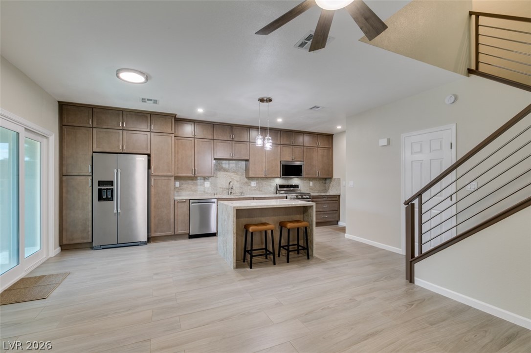 540 Sutters Mill Road Henderson, NV 89014 - Photo 19 of 46 This open-concept area features a contemporary kitchen seamlessly flowing into the living space with access to the outdoors.