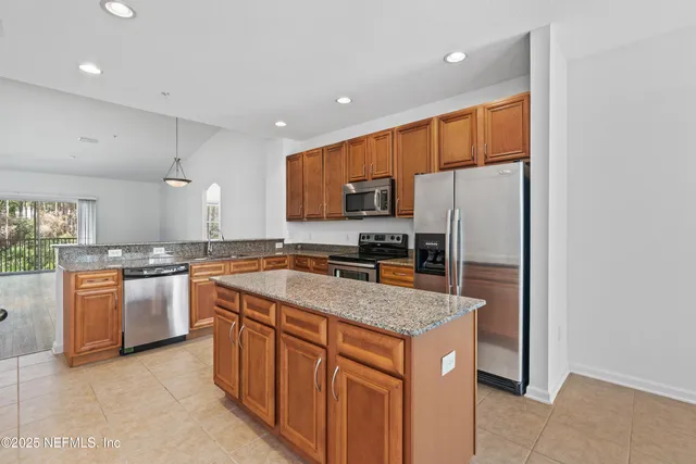 a spacious bathroom with a granite countertop double vanity sink a mirror and a shower