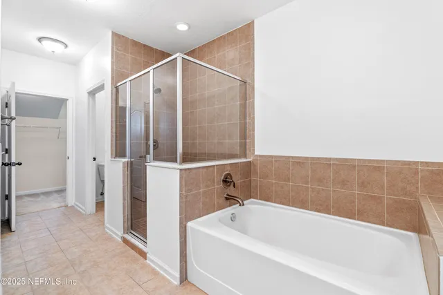 an aerial view of a house with a yard and swimming pool