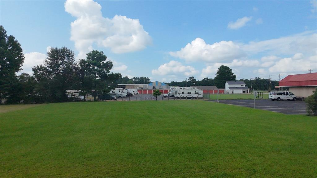 0 Industrial Road Shreveport, LA 71129 - Photo 2 of 7 a green field with lots of trees in the background