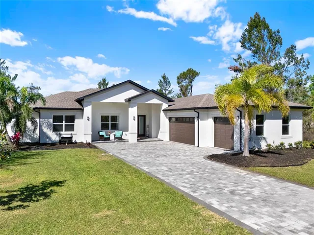 a front view of a house with swimming pool and porch with furniture