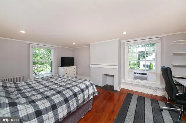 a bedroom with a bed and a large window with outer view