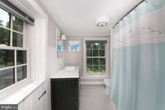 a bathroom with a sink vanity and a mirror