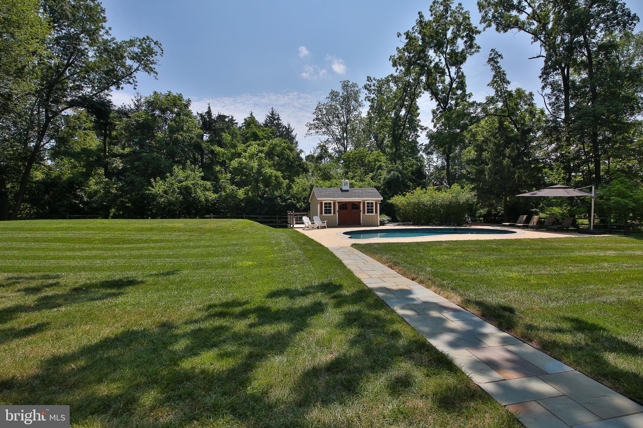 4964 Point Pleasant Pike Doylestown, PA 18902 - Photo 22 of 28 Serene backyard oasis with pool and greenery.