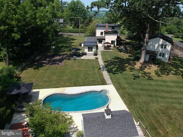 an aerial view of a house with a yard and lake view