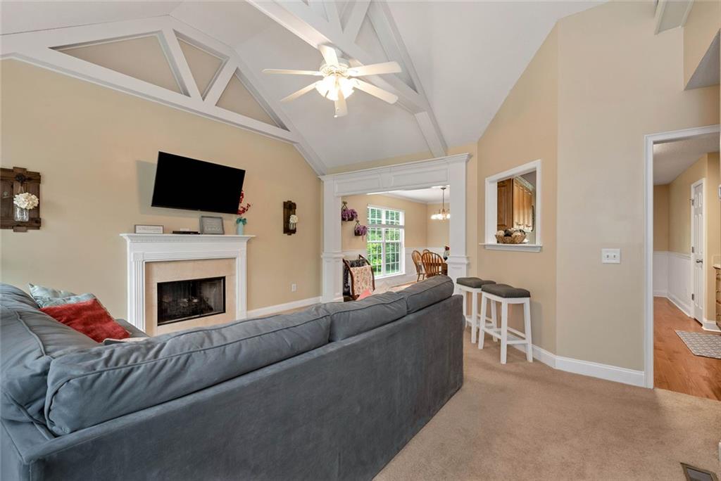 1044 Lothridge Road Cleveland, GA 30528 - Photo 11 of 40 a living room with furniture a flat screen tv and a fireplace