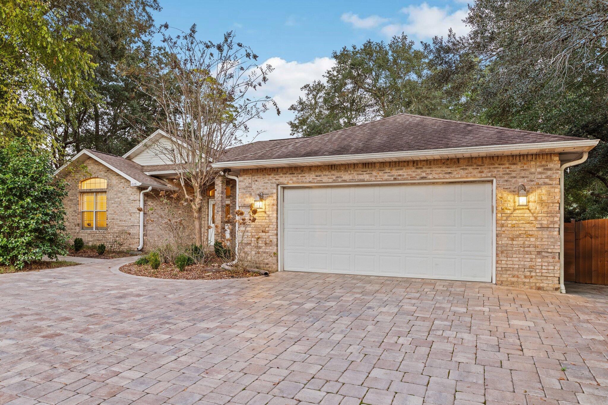 1825 Huntington Road Niceville, FL 32578 - Photo 1 of 68 a front view of a house with a yard and garage